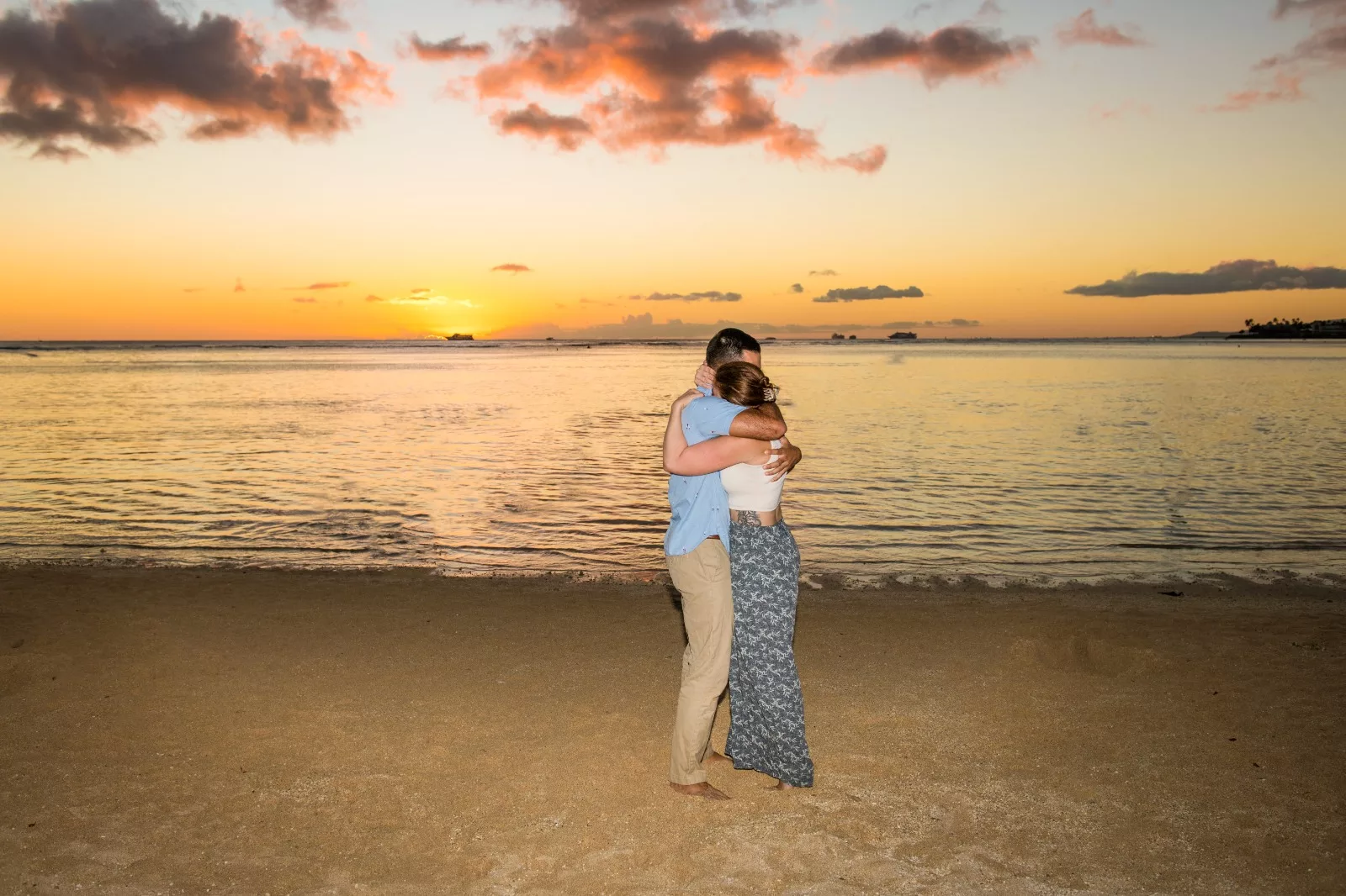 an image of a couple in the beach hugging captured by koolina photographer