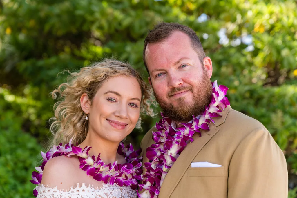 An image of a couple smiling in front of a oahu hawaii photographer for their photoshoot