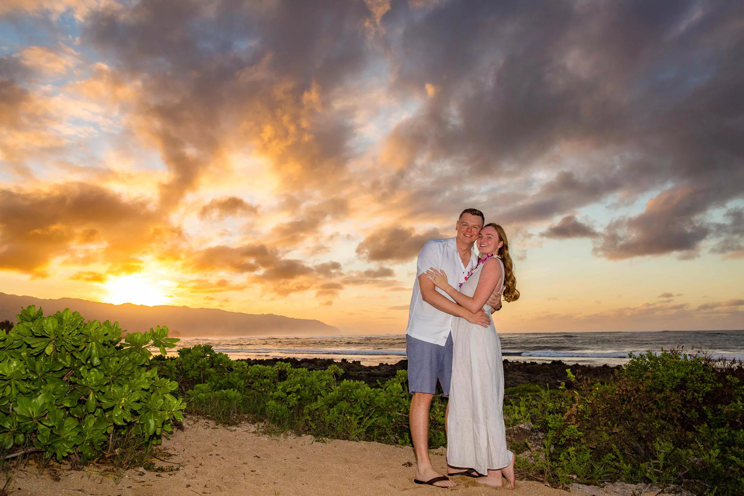 an image of a couple on the beach having their proposal photoshoot captured by north shore photographer oahu hawaii photography