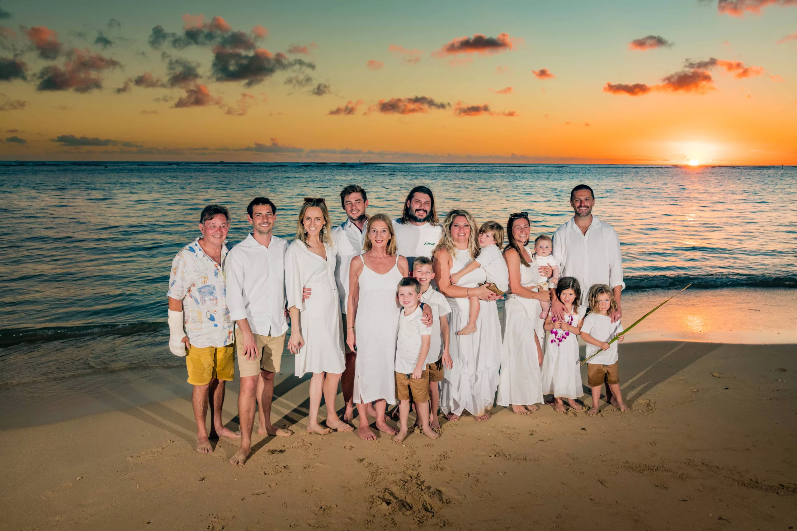 an image of a big family at waikiki beach taken by Waikiki Family Photographer